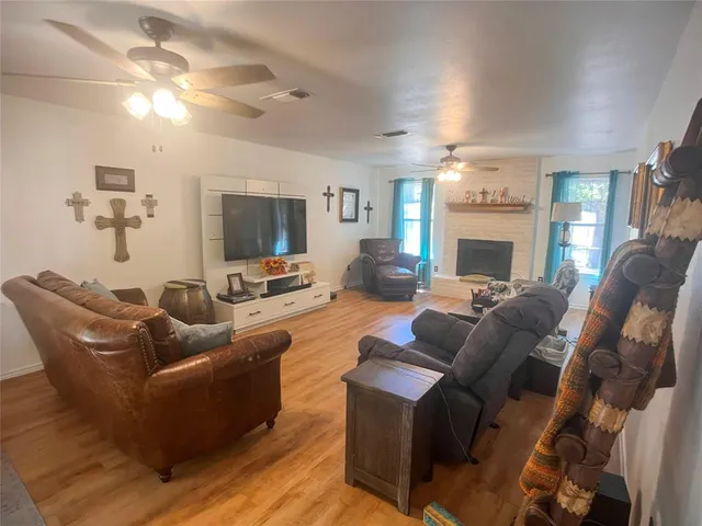 a living room with furniture a fireplace and a flat screen tv