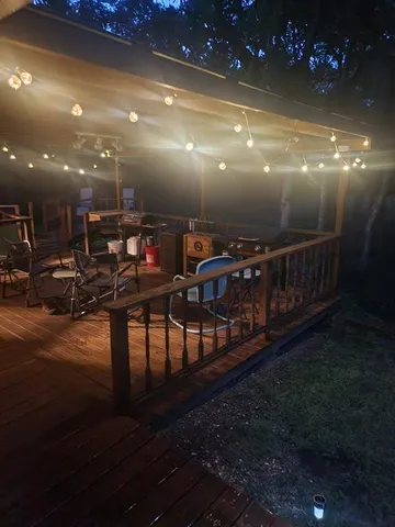a view of a porch with chairs and potted plants