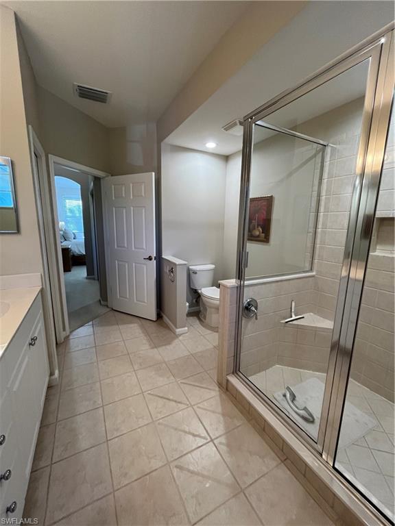 6809 Ascot Drive, Unit 202 Naples, FL 34113 - Photo 13 of 38 a bathroom with a glass shower door and a sink