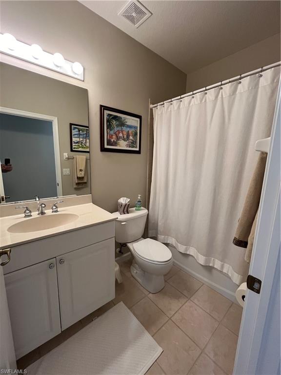 6809 Ascot Drive, Unit 202 Naples, FL 34113 - Photo 16 of 38 a bathroom with a sink mirror vanity and toilet
