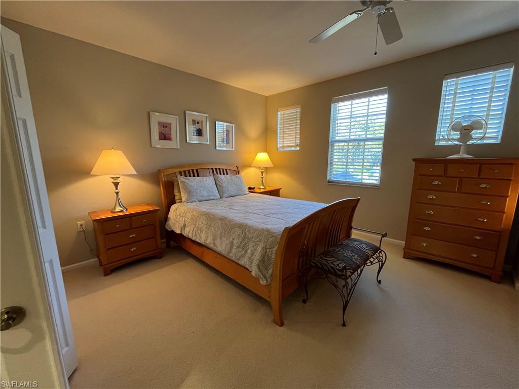 6809 Ascot Drive, Unit 202 Naples, FL 34113 - Photo 17 of 38 a bedroom with a bed and a window