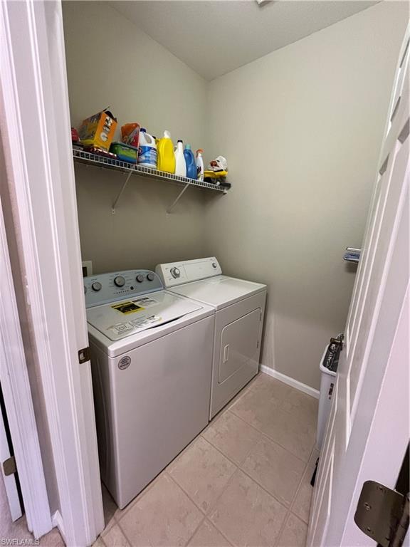 6809 Ascot Drive, Unit 202 Naples, FL 34113 - Photo 19 of 38 a utility room with dryer and washer