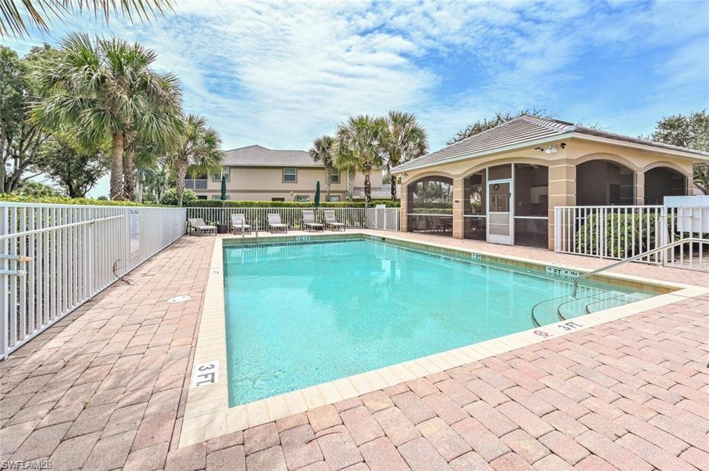6809 Ascot Drive, Unit 202 Naples, FL 34113 - Photo 24 of 38 a view of a house with backyard and sitting area