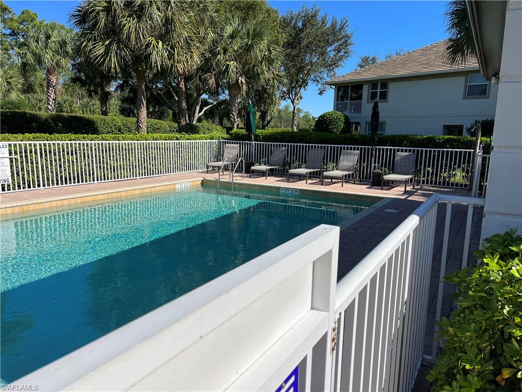 6809 Ascot Drive, Unit 202 Naples, FL 34113 - Photo 26 of 38 a view of backyard with swimming pool and outdoor seating
