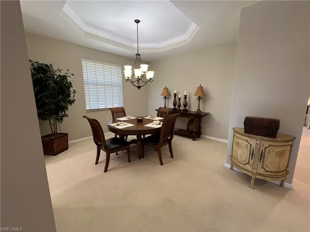 a view of a dining room with furniture and chandelier