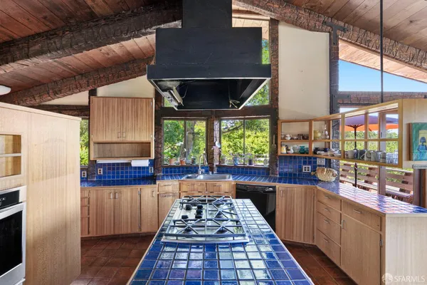 a kitchen with a large window in it and kitchen