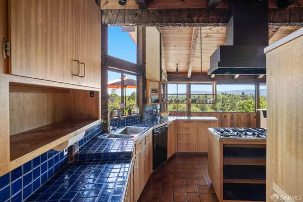 a kitchen with a sink and a stove top oven