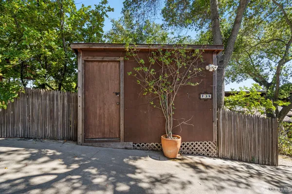 a backyard of a house with a tree