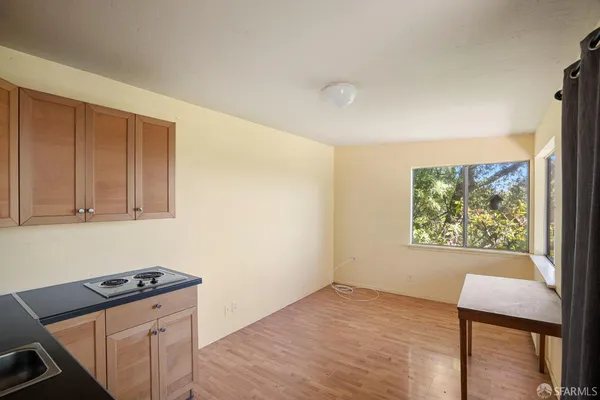 a view of a kitchen with a sink and a large window
