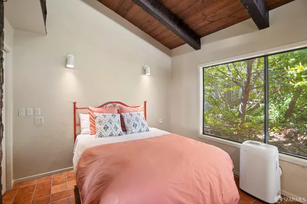 a bedroom with a bed and a ceiling fan
