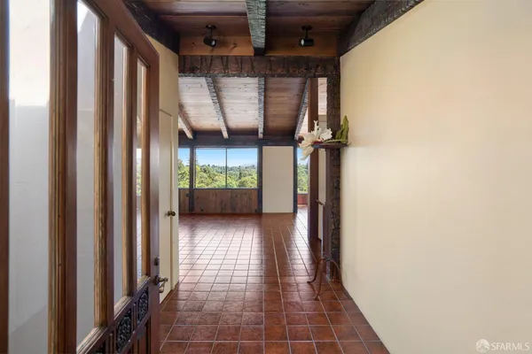 a view of a hallway with wooden walls and windows