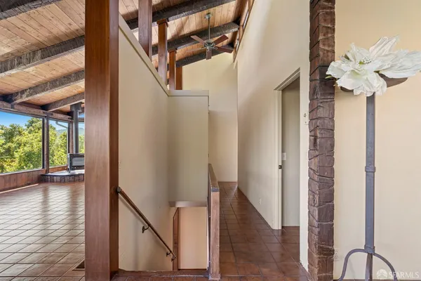 a bedroom with furniture and large window