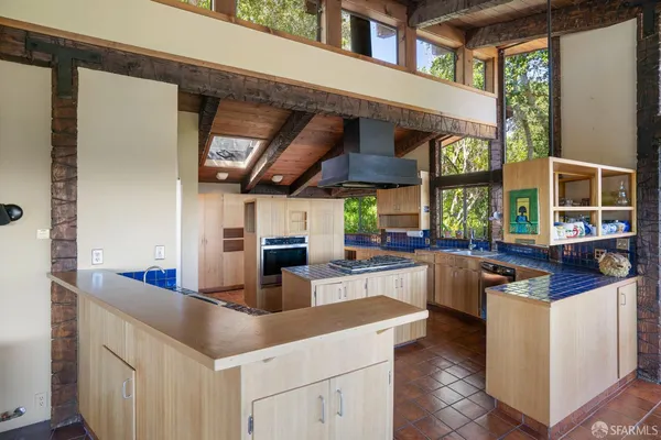 a kitchen with stainless steel appliances granite countertop a sink and a stove