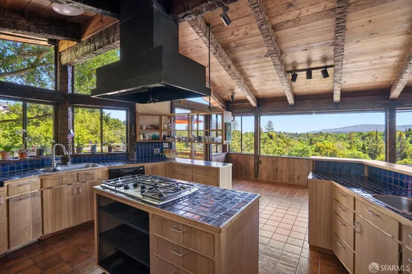a kitchen with stainless steel appliances granite countertop a stove and a wooden cabinets