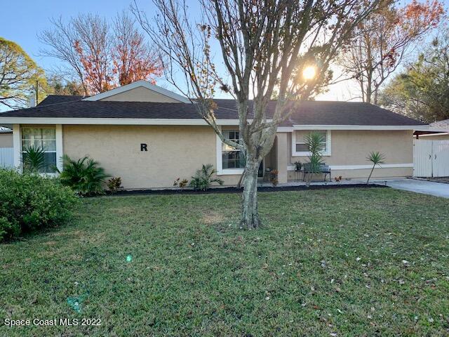 235 Capron Road Cocoa, FL 32927 - Photo 1 of 19 a front view of house with yard and trees