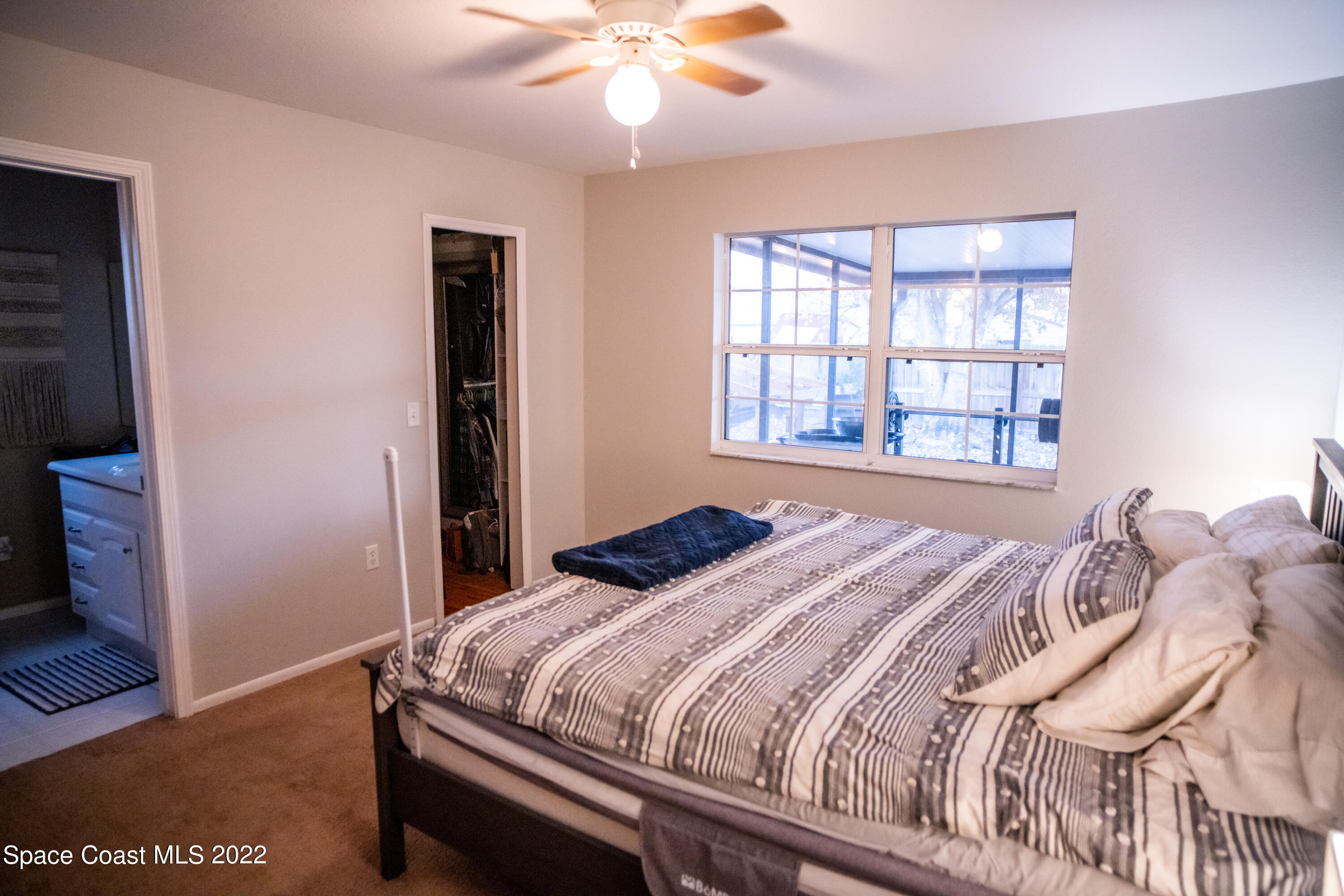 235 Capron Road Cocoa, FL 32927 - Photo 11 of 19 a bedroom with a bed and a window