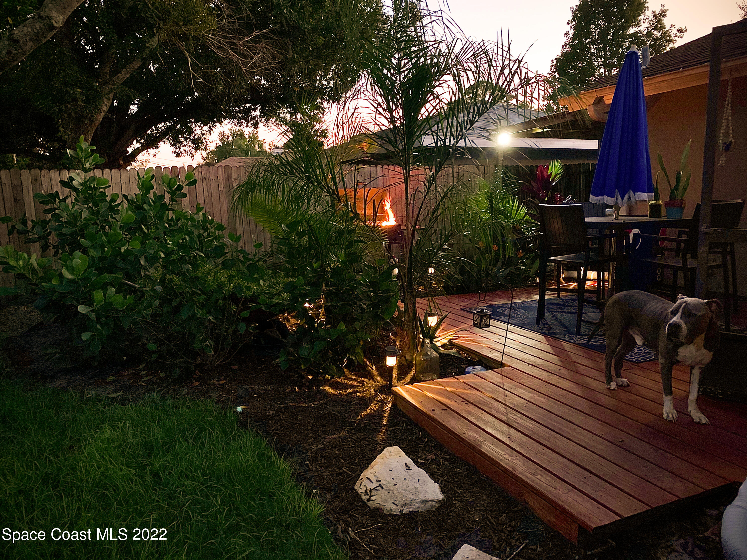 235 Capron Road Cocoa, FL 32927 - Photo 15 of 19 a view of a patio with table and chairs with wooden floor and fence