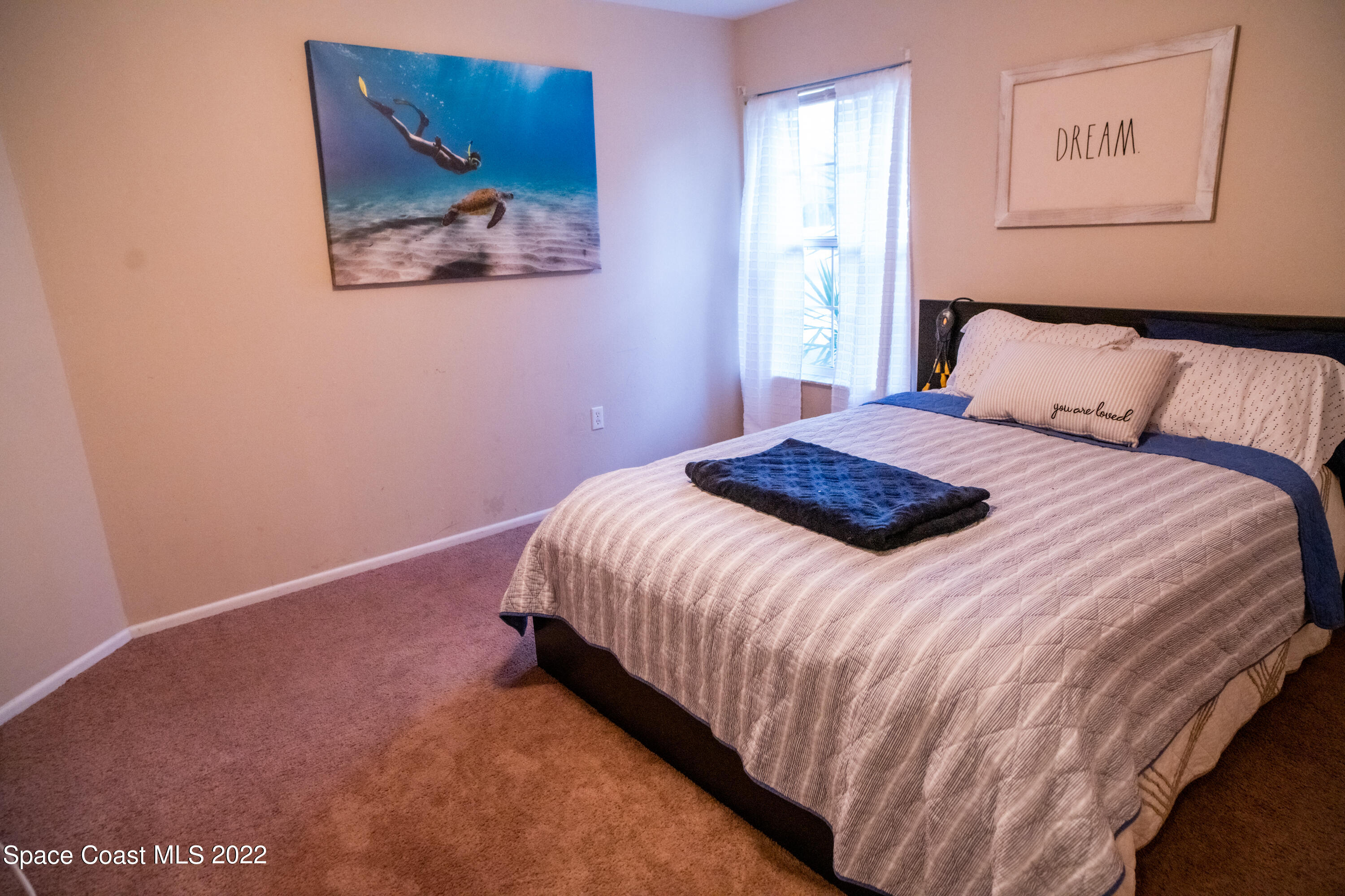 235 Capron Road Cocoa, FL 32927 - Photo 9 of 19 a bedroom with a bed and wall painting