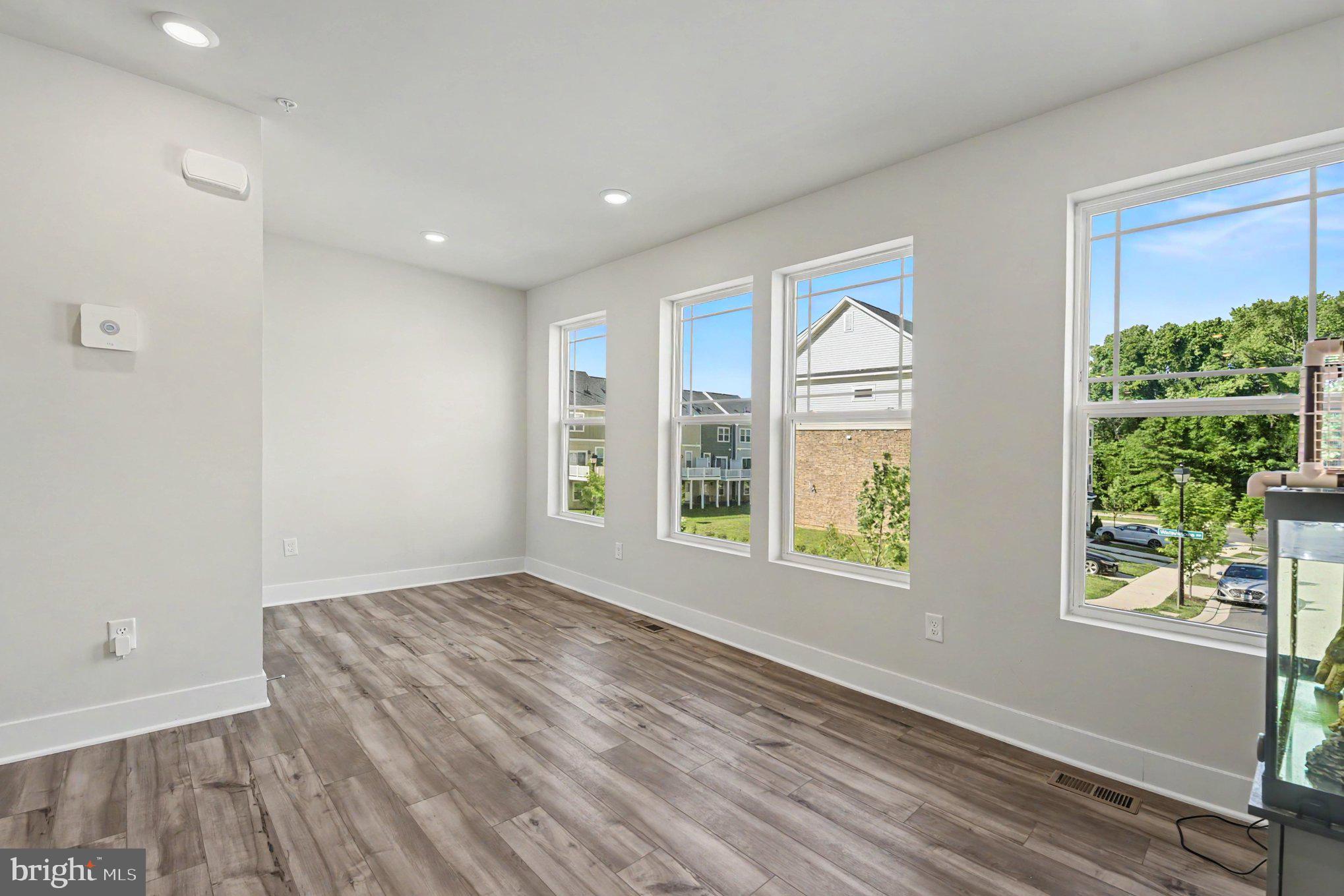 238 Waterstone Road Essex, MD 21221 - Photo 12 of 39 wooden floor in an empty room with a window