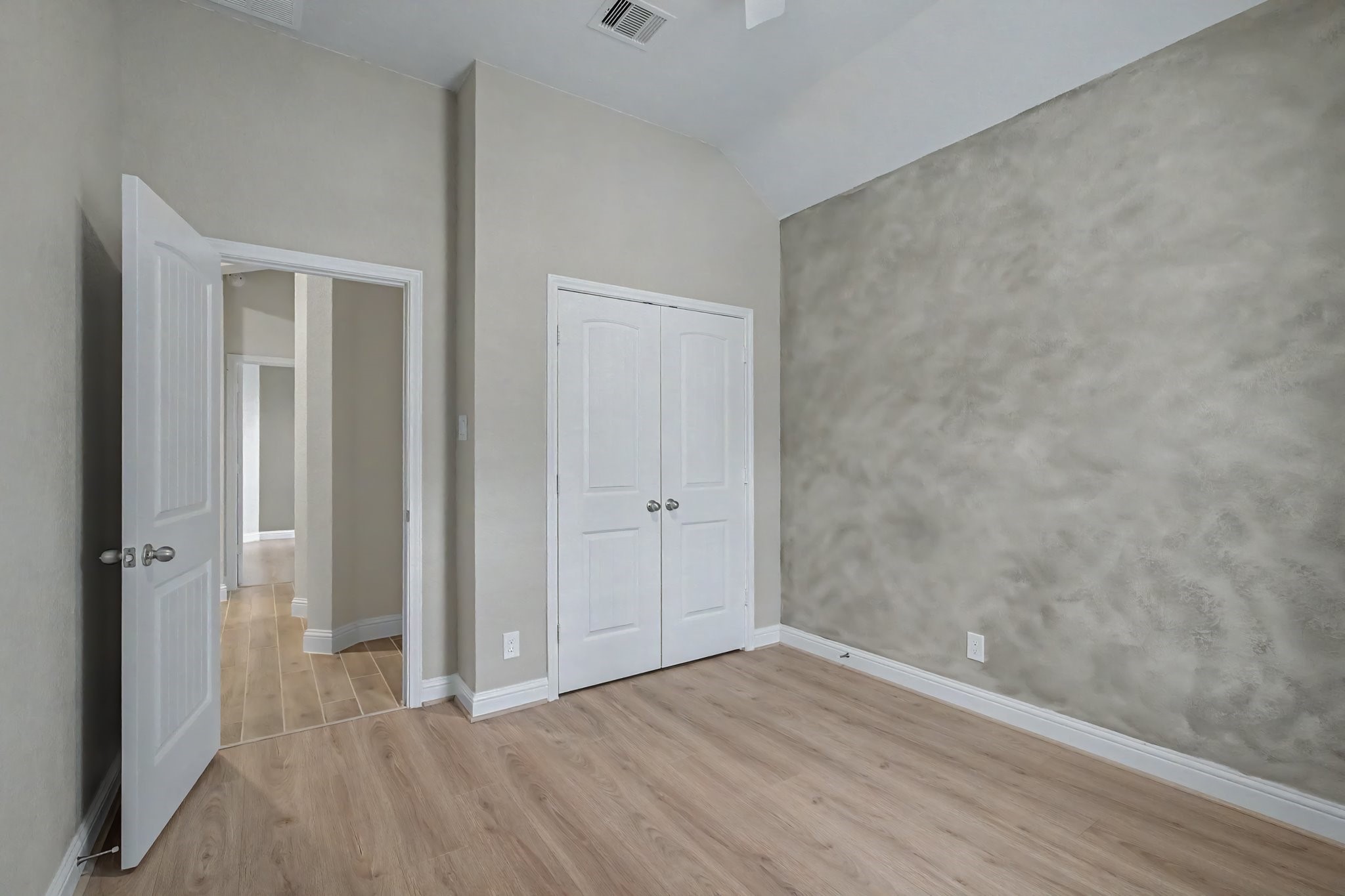 21339 Sierra Point Lane Porter, TX 77365 - Photo 27 of 36 This cozy room features light wood flooring, a textured wall, and a window with white curtains, providing natural light and a neutral palette for versatile decor.