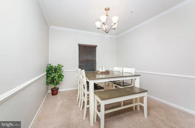 a view of a dining room with furniture and a chandelier