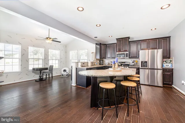 a large kitchen with a table and chairs