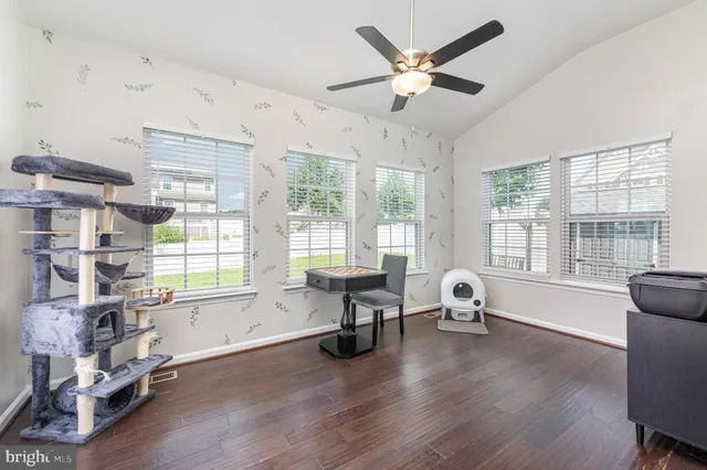 a view of kitchen and living room with wooden floor