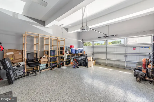 a view of a house with backyard and white fence