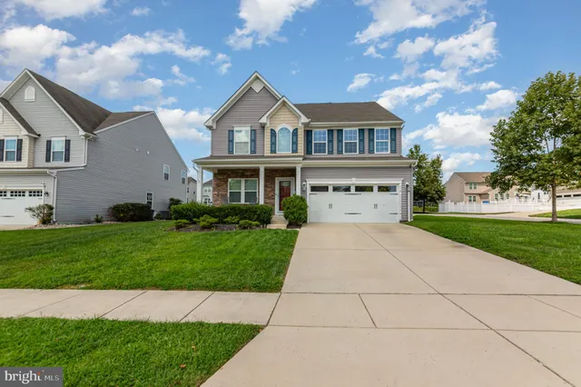 a view of house with yard and entertaining space