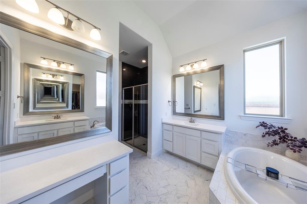 1650 Oakcrest Drive Prosper, TX 75078 - Photo 22 of 40 Full bathroom with a bath, two vanities, a stall shower, and lofted ceiling