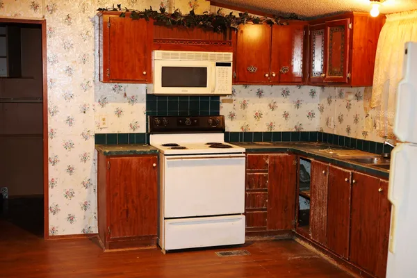 a kitchen with stainless steel appliances a stove microwave and cabinets