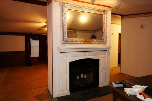 a living room with a fireplace and a flat screen tv