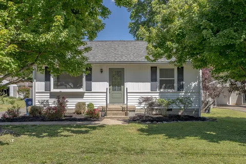 a front view of house with yard and green space