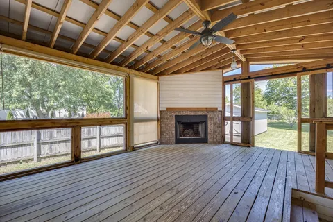 a view of a porch with wooden floor