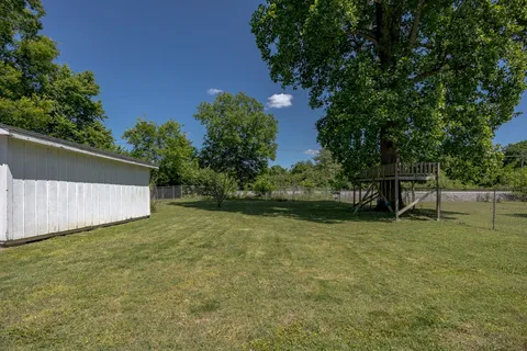 a view of a house with a backyard