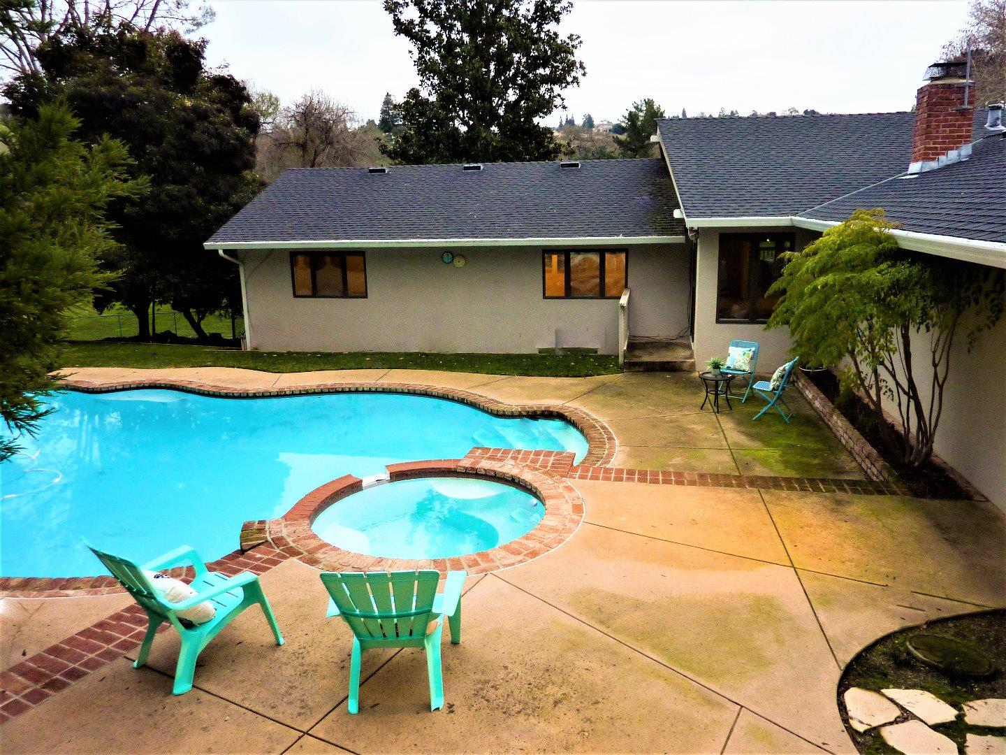 17080 Copper Hill Drive Morgan Hill, CA 95037 - Photo 35 of 38 a view of a house with swimming pool and sitting area