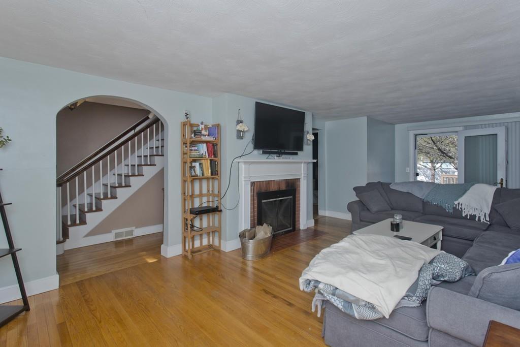 38 Pine Acre Road Springfield, MA 01129 - Photo 16 of 40 a living room with furniture a flat screen tv and a fireplace