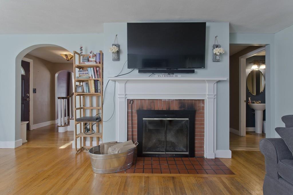 38 Pine Acre Road Springfield, MA 01129 - Photo 19 of 40 a living room with a fireplace and a flat screen tv