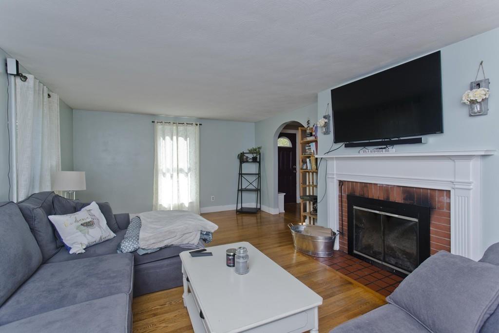 38 Pine Acre Road Springfield, MA 01129 - Photo 4 of 40 a living room with furniture a flat screen tv and a fireplace