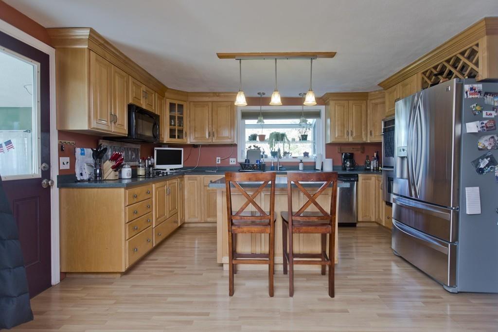 38 Pine Acre Road Springfield, MA 01129 - Photo 9 of 40 a kitchen with stainless steel appliances granite countertop a refrigerator a microwave a sink and chairs