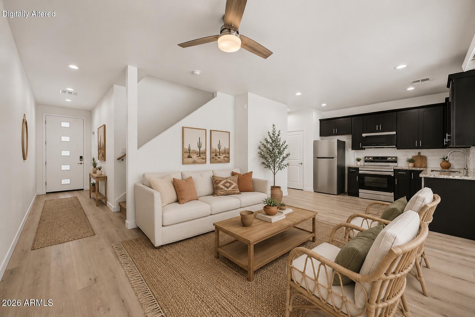 105 West Latona Road Phoenix, AZ 85041 - Photo 9 of 53 a living room with furniture a kitchen view and a chandelier