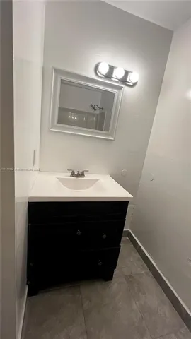 a white toilet sitting next to a bathroom sink and tub