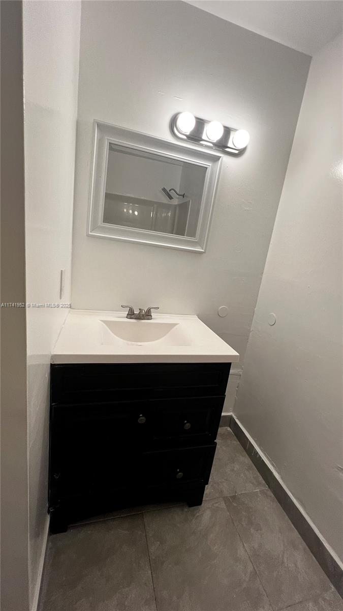 4372 West 11th Lane, Unit 30 Hialeah, FL 33012 - Photo 18 of 23 a bathroom with a sink vanity and a mirror