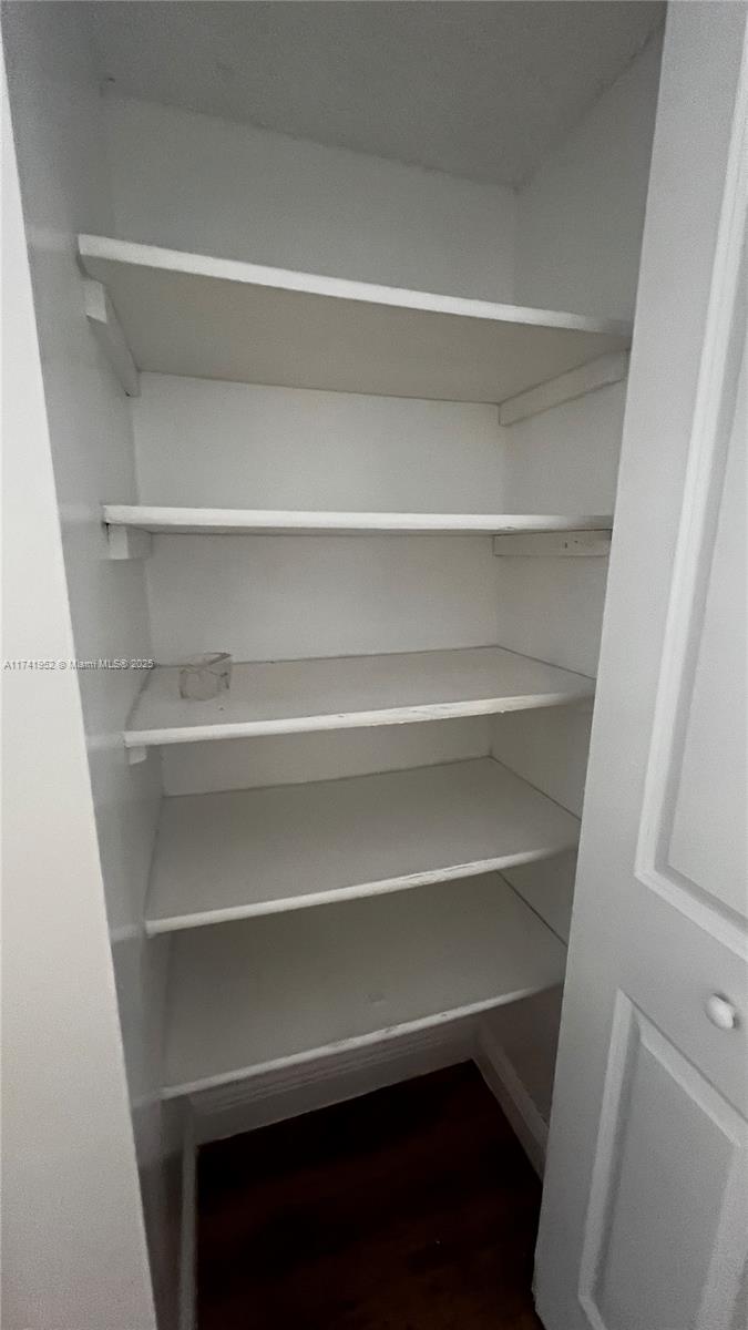 4372 West 11th Lane, Unit 30 Hialeah, FL 33012 - Photo 20 of 23 a view of walk in closet with empty racks