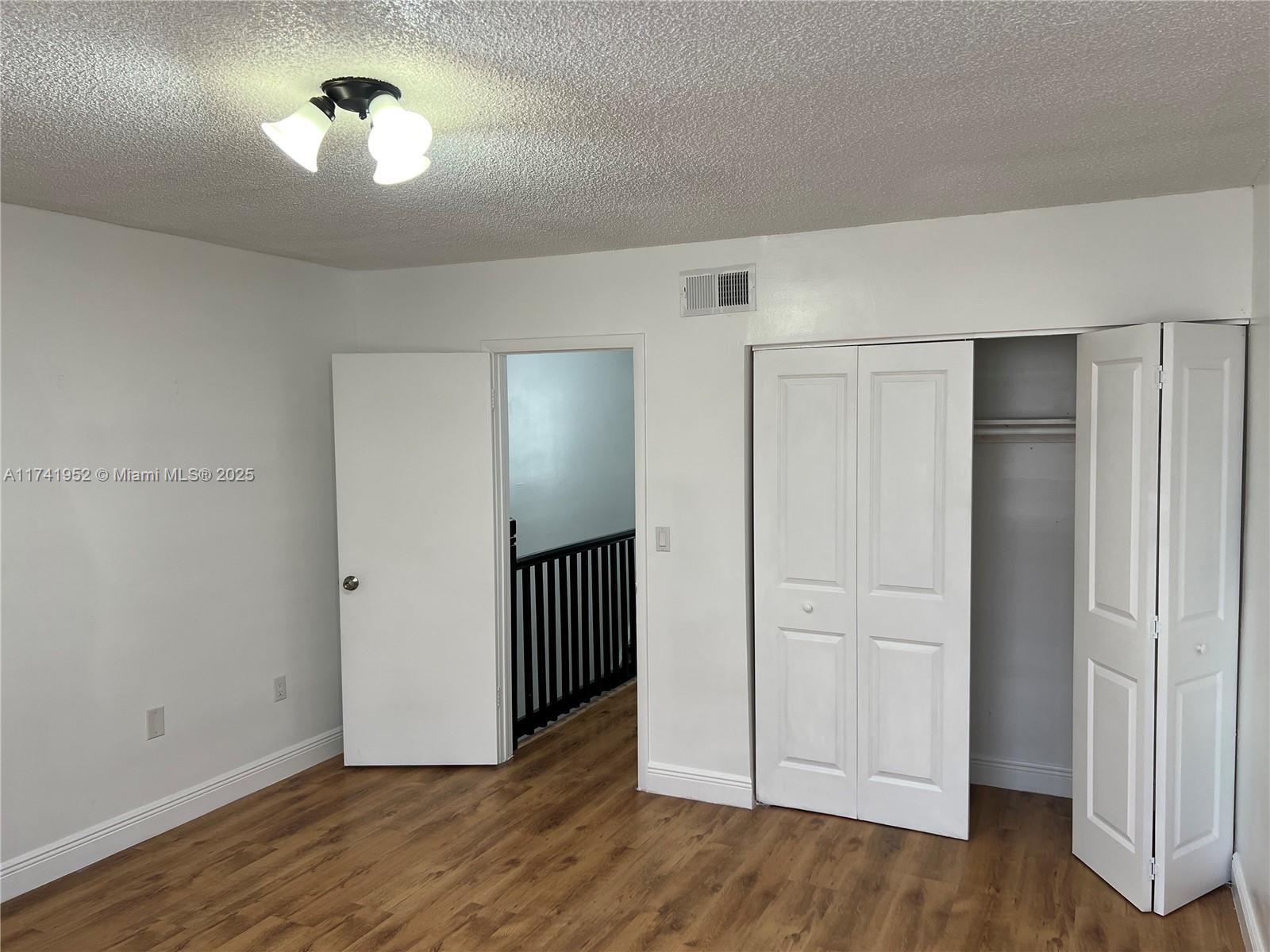 4372 West 11th Lane, Unit 30 Hialeah, FL 33012 - Photo 21 of 23 a view of empty room with wooden floor