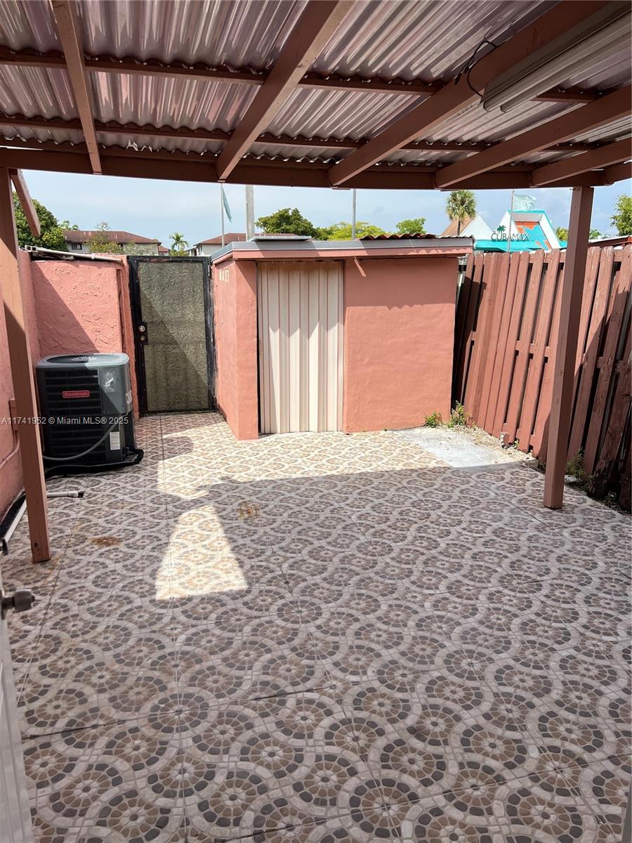 4372 West 11th Lane, Unit 30 Hialeah, FL 33012 - Photo 22 of 23 a front view of a house with a wooden floor