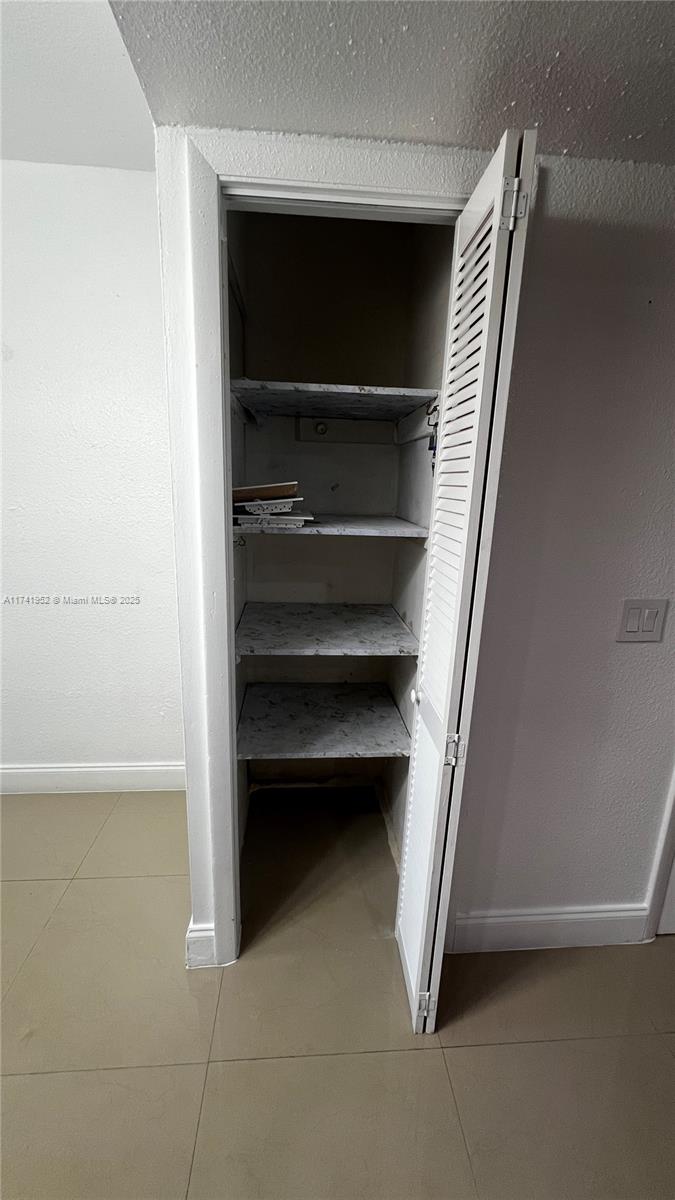 4372 West 11th Lane, Unit 30 Hialeah, FL 33012 - Photo 7 of 23 a view of walk in closet with empty racks