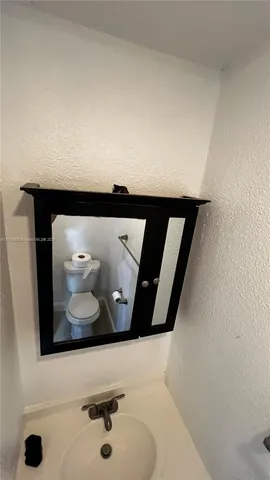 a bathroom with a sink and mirror