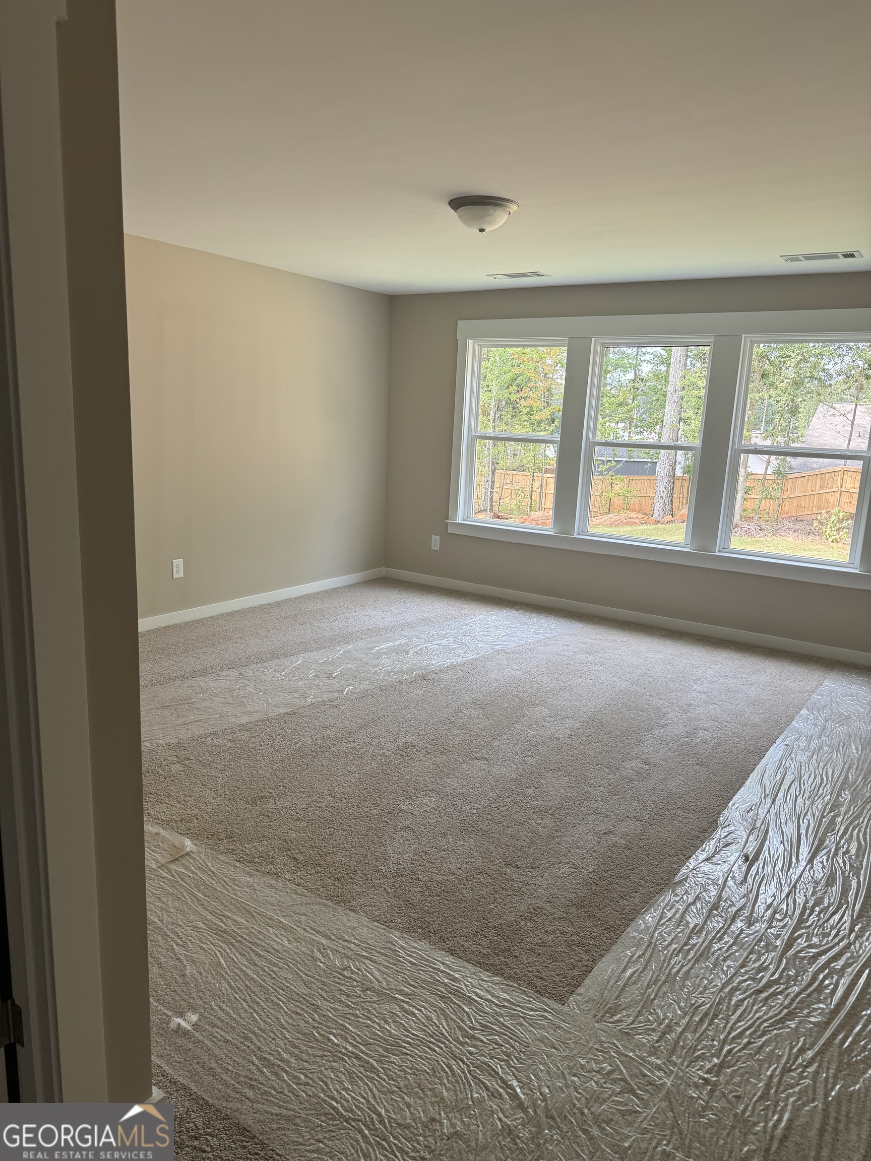 258 Westminster Court Winder, GA 30680 - Photo 12 of 16 a view of an empty room with a window