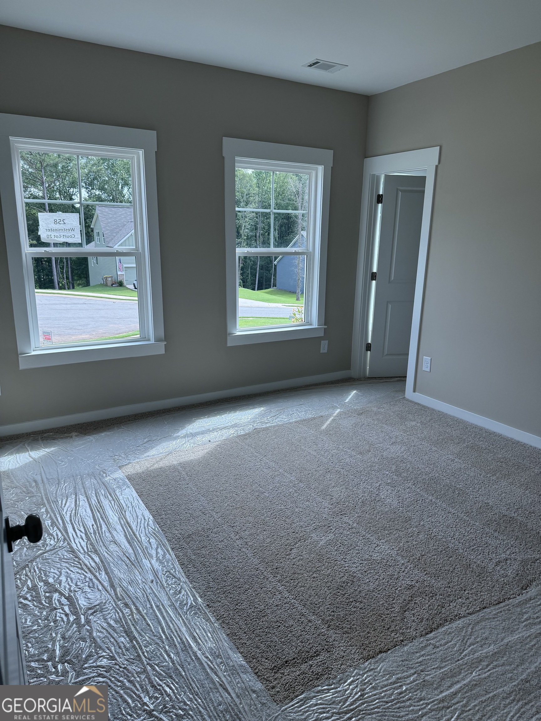 258 Westminster Court Winder, GA 30680 - Photo 10 of 16 a view of empty room with wooden floor and fan